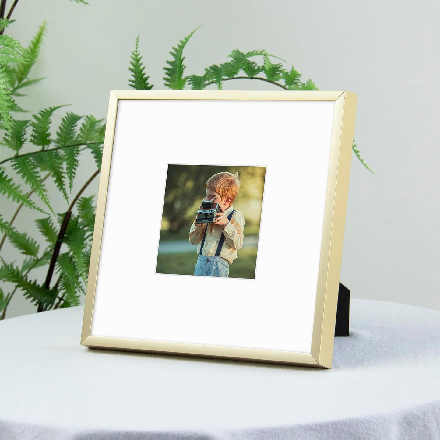 Frametory, 8X8 Gold Aluminum Picture Frame - Set of 1 - Ideal for Displaying 4X4 Photos with Mat or 8X8 without Mat - Real Glass Front - Simple Gallery Wall Frames for Art Prints and Posters